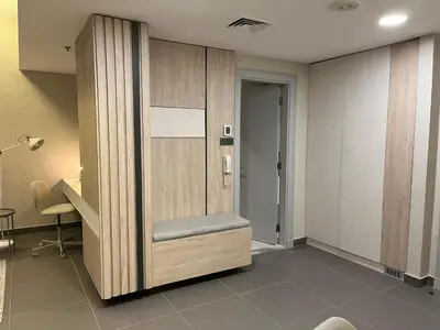 a waiting room with a chair and a desk at DAMAC Luxury new 1 bedroom apartment in Amman