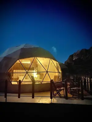 a large dome tent with tables and chairs in it at Wadi Rum Desert Bedouins in Wadi Rum