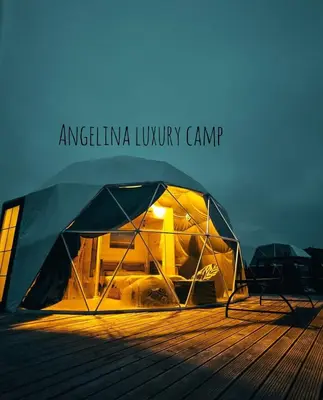 a tent sitting on top of a wooden deck at Angelina Luxury Camp in Wadi Rum