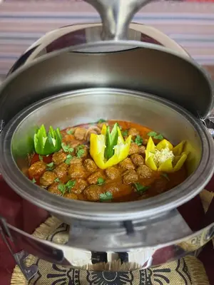 a pot of stew with meat and vegetables in it at SARAB Luxury Camp in Wadi Rum