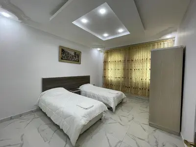 a bedroom with two beds and a window at Oskar Appartment in Wadi Musa