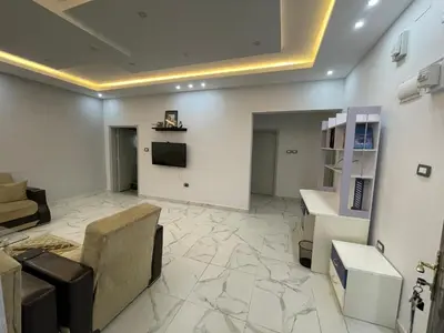 a living room with a tv and a couch and a table at Oskar Appartment in Wadi Musa