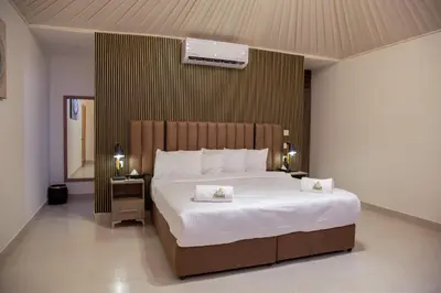 a bedroom with a large bed with two towels on it at Omsiat Shahrazad Luxury Camp in Wadi Rum