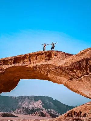 two people standing on top of a rock formation at Wadi Rum Beyond nature in Wadi Rum