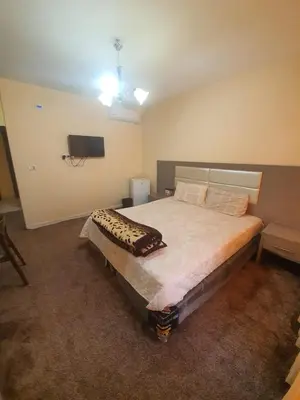 a bedroom with a large bed in a room at Alfares Hotel in At-Tafilah