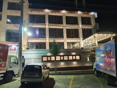 a car parked in front of a building at night at Alfares Hotel in At-Tafilah
