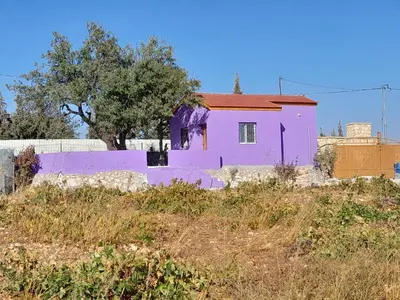 a purple house on the side of a hill at Jerash mountain studio chalet شاليه جبال جرش و عجلون in Jerash