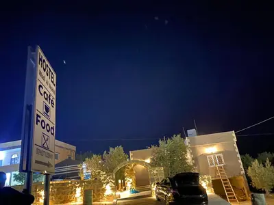 a car parked in a parking lot in front of a building at Wadi Al-Nakhil Hostel in Al Khuraybah
