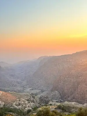 a view of a valley from a mountain at sunset at Wild Dana Eco Lodge- Hotel-Eco-Camp in Dana