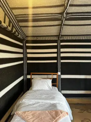 a bed in a room with black and white stripes at Wild Dana Eco Lodge- Hotel-Eco-Camp in Dana
