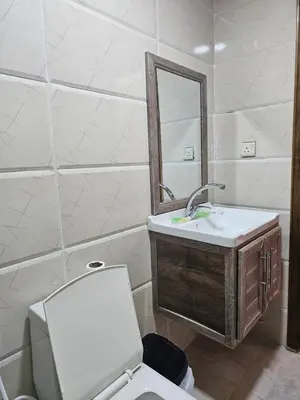 a bathroom with a toilet and a sink and a mirror at MAXIMAS LUXURY Wadi Rum in Wadi Rum