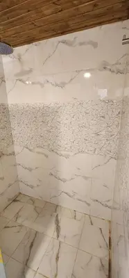 a white marble wall in a bathroom at MAXIMAS LUXURY Wadi Rum in Wadi Rum