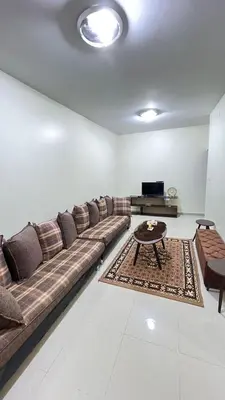 a living room with a couch and a coffee table at Sara apartment in Wadi Musa