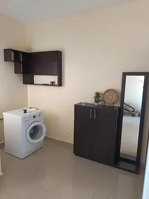 a laundry room with a washing machine and a mirror at Sara apartment in Wadi Musa
