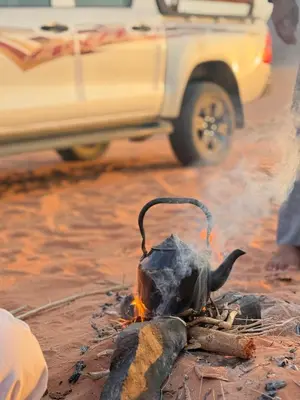 a fire in the middle of a street with a truck at Tamim Luxury wadi rum camp in Wadi Rum