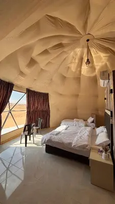 a bedroom with a bed in a tent at SELEN RUM LUXURY CAMP & Jeep Tours in Wadi Rum