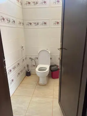 a bathroom with a white toilet in a room at Wadi Rum Time in Wadi Rum