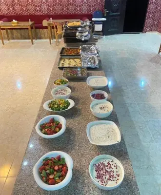a buffet line with bowls of different types of food at Amazing Wadi Rum Camp in Wadi Rum