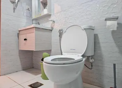 a bathroom with a toilet with the lid up at Amazing Wadi Rum Camp in Wadi Rum