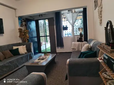 a living room with couches and a table at Seleucia DaR Umm Qais in Um Qeis