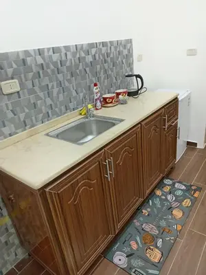 a kitchen with a sink and a counter top at EMILE ALTWAL Hotel in Madaba