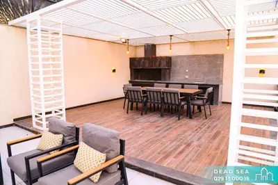 a room with a table and chairs and a piano at PYRAMID Chalets - شاليهات الهرم in Al Baḩḩāth