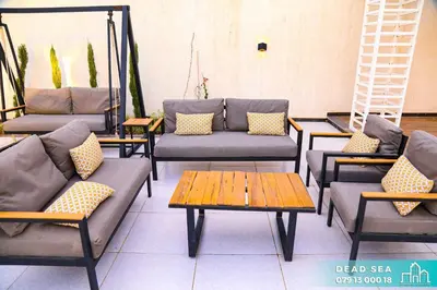 a group of couches and tables in a room at PYRAMID Chalets - شاليهات الهرم in Al Baḩḩāth