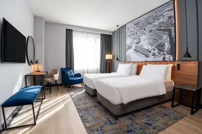 a hotel room with a bed and a desk at Radisson Blu Hotel, Amman Galleria Mall in Amman