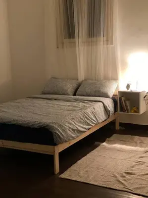 a bed in a room with a window and a bed sidx sidx sidx at Homey Apt. with beautiful view in Amman
