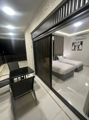 a bedroom with a bed and a mirror in it at cozy home near all services 20 in Rujm ash Sharāʼirah