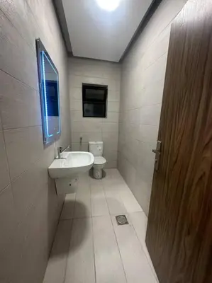 a bathroom with a sink and a toilet at cozy home near all services (22) in Rujm ash Sharāʼirah