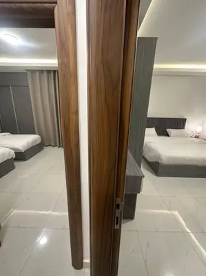 a view of a room with two beds and a door at cozy home near all services (22) in Rujm ash Sharāʼirah