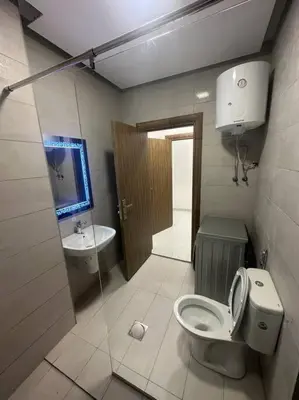 a bathroom with a toilet and a sink at cozy home near all services (22) in Rujm ash Sharāʼirah