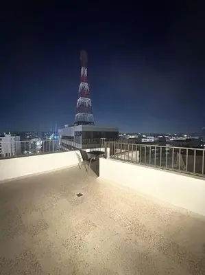 a view of a lighthouse on top of a building at cozy rooftop near al services 23 in Rujm ash Sharāʼirah