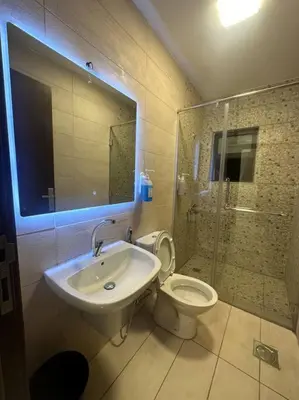 a bathroom with a sink and a toilet and a shower at cozy rooftop near al services 23 in Rujm ash Sharāʼirah