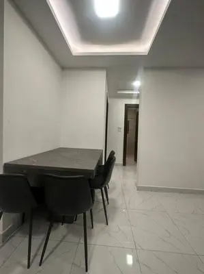 a meeting room with a table and black chairs at cozy rooftop near al services 24 in Rujm ash Sharāʼirah