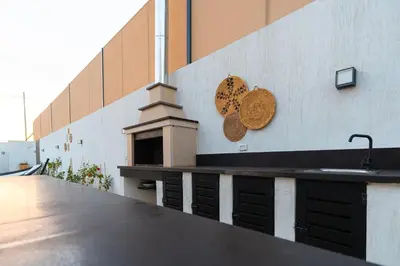 a counter with a sink on the side of a building at Nammos Experience in Amman