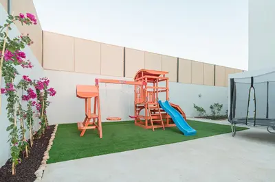 a playground with two chairs and a slide at Nammos Experience in Amman
