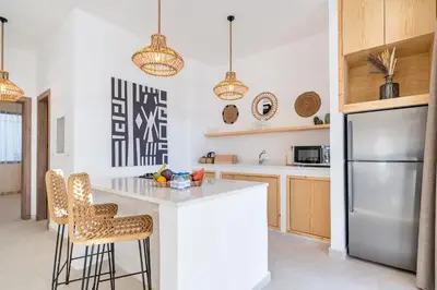 a kitchen with a counter and a refrigerator at Nammos Experience in Amman