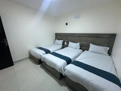two beds in a hotel room with at Happy Beach Castel for Apartment قلعة شاطئ السعادة للشقق المفروشة in Aqaba