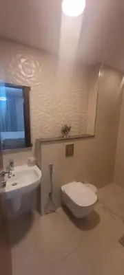 a bathroom with a white toilet and a sink at Abdoun luxurious apartment in Amman