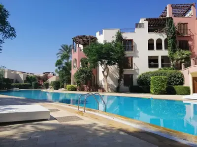 a swimming pool in front of a building at Talabay Top cosy 3 bedroom apartment in Aqaba