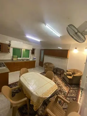 a room with a table and chairs and a kitchen at شقه مفروشه مميزه in Irbid