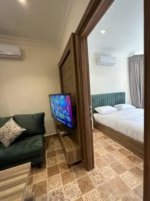 a bedroom with a bed and a tv and a couch at 1/ Antica jabalal-lwebdeh in Amman