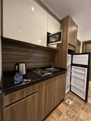 a kitchen with a stove and a refrigerator at 1/ Antica jabalal-lwebdeh in Amman