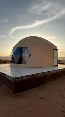 a dome shaped building on top of a dirt field at Madonna Rum camp bubbles & Jeep tours in Wadi Rum