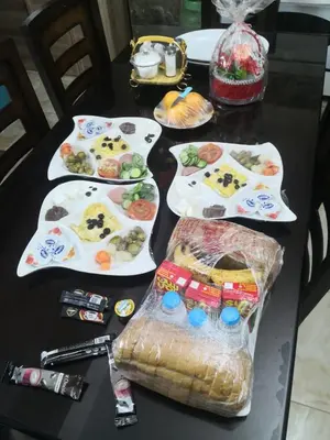a black table with plates of food on it at white tulips studio in Jerash