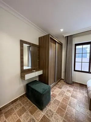 a room with a sink and a mirror and a stool at 3/ Antica jabalal-lwebdeh in Amman