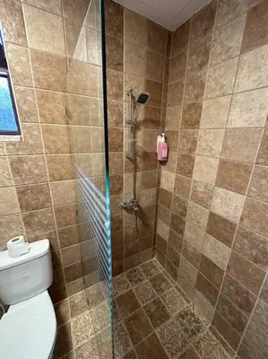 a bathroom with a shower and a toilet at 3/ Antica jabalal-lwebdeh in Amman
