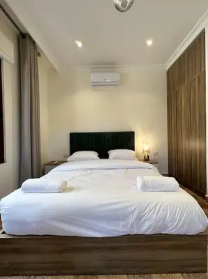 a bedroom with a large white bed with two pillows at 4/ Antica jabalal-lwebdeh in Amman